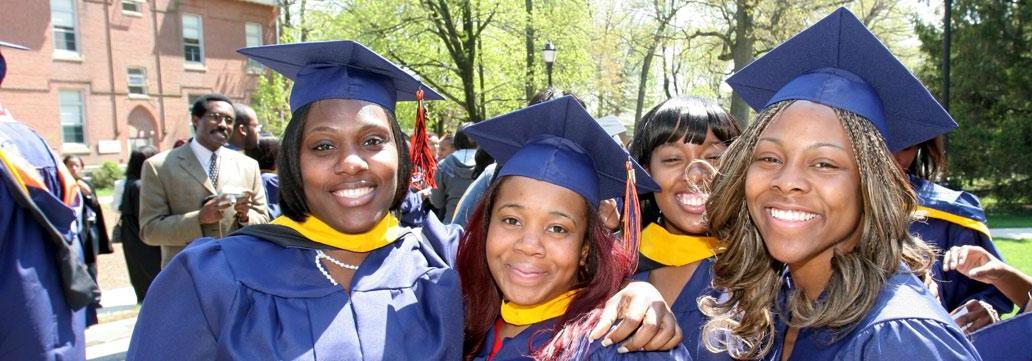 Four graduation women with graduation caps